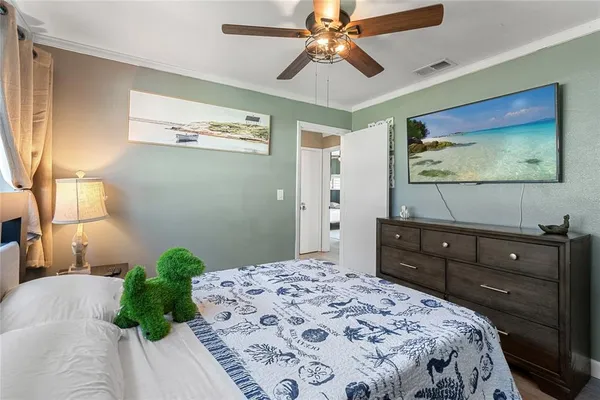 a bedroom with a bed and a flat screen tv