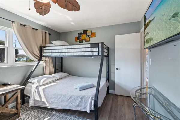 a bedroom with a bed and a chandelier