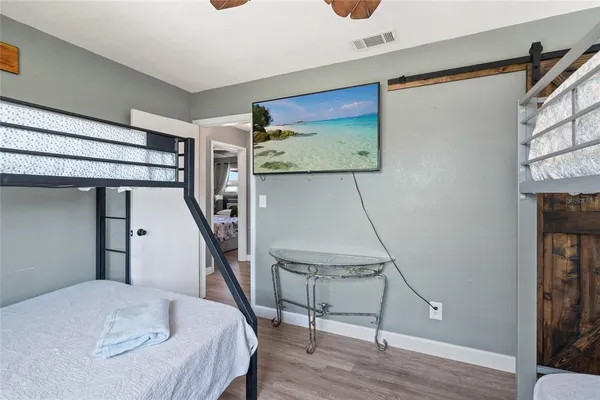 a bedroom with a bed and a flat screen tv