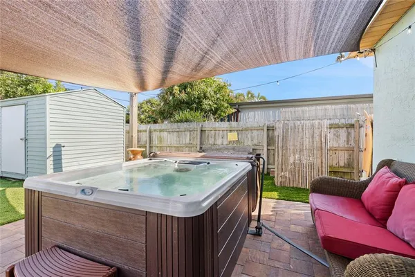 a view of backyard with a tub and outdoor seating