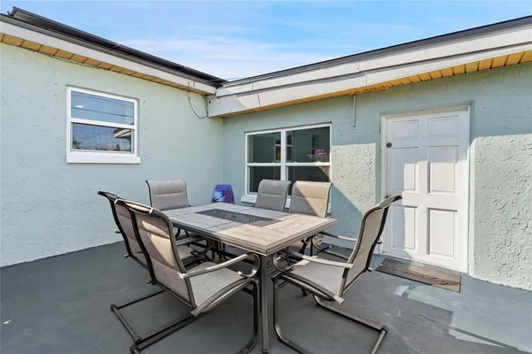 a view of a dining room with furniture and window