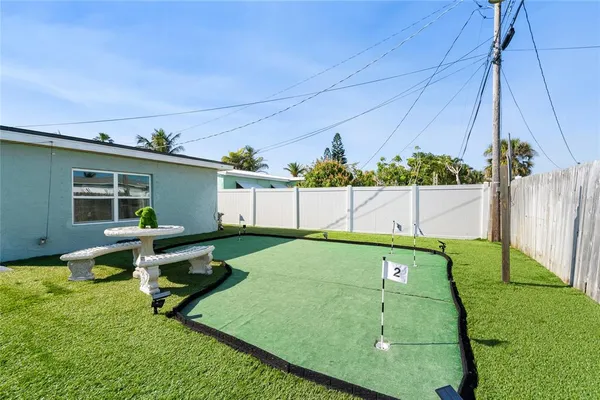 a backyard of a house with table and chairs