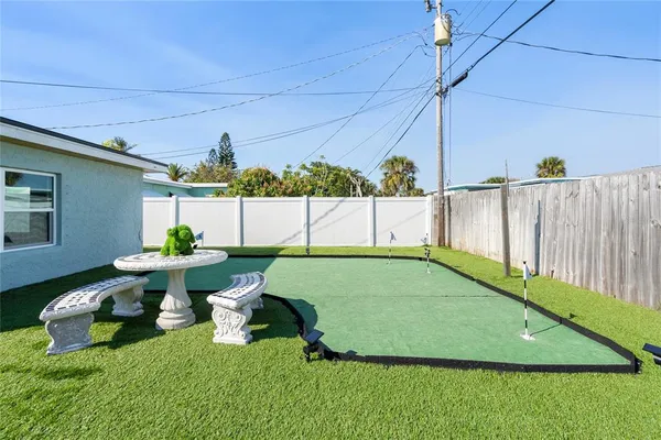 a view of backyard with seating area and trees