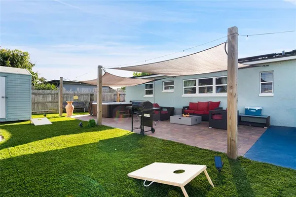 a view of a house with a backyard and a patio