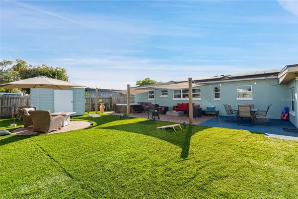 a view of a house with swimming pool and a yard