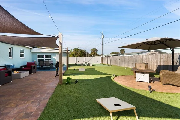 a view of a patio with a table and chairs under an umbrella