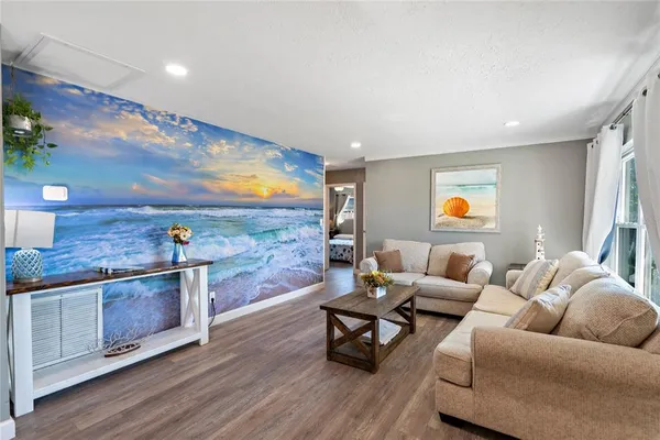 a living room with furniture and wooden floor