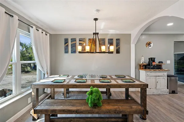a dining room with furniture a rug and wooden floor