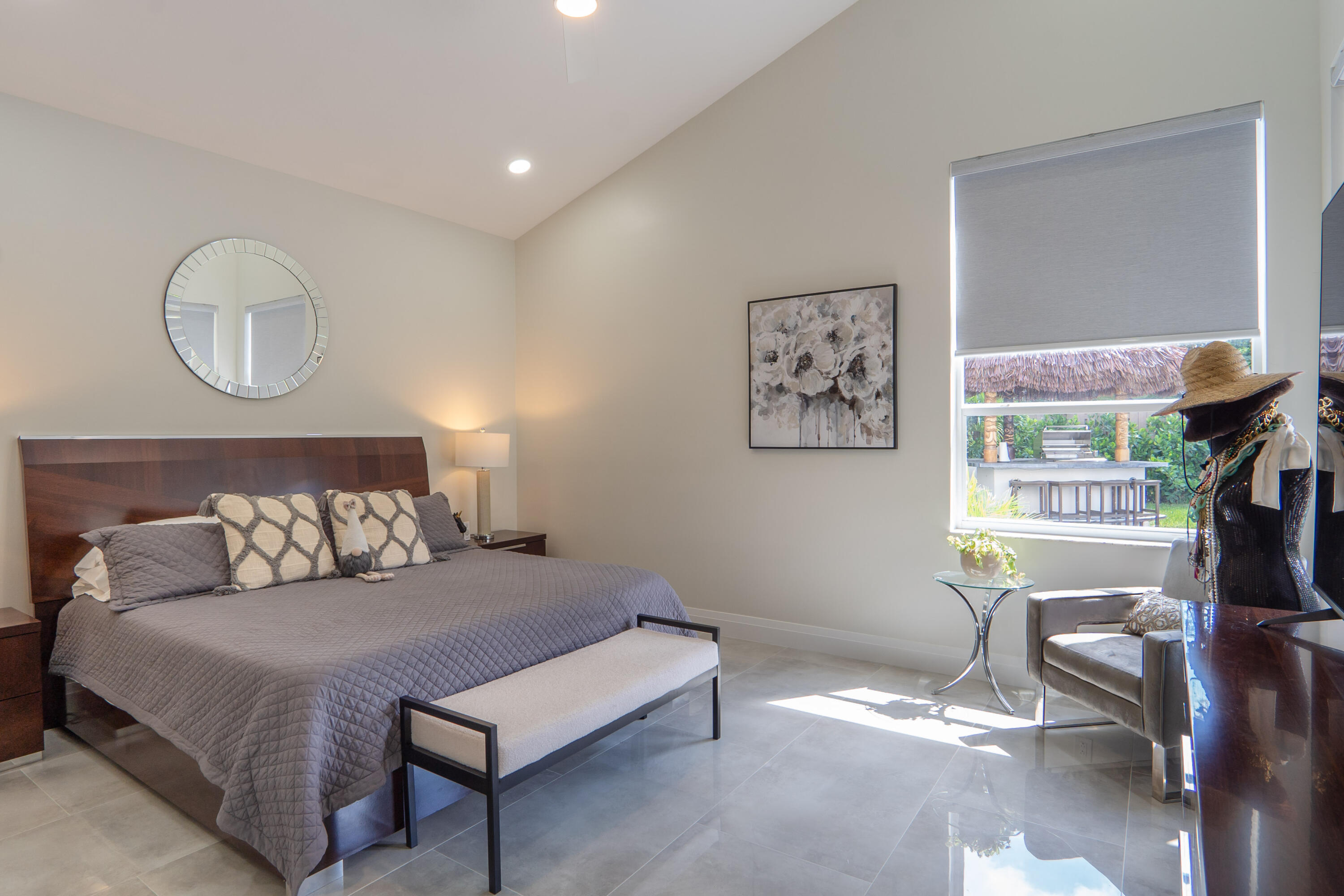 6670 Northwest 27th Avenue Boca Raton, FL 33496 - Photo 16 of 43 a bedroom with a bed window and couch