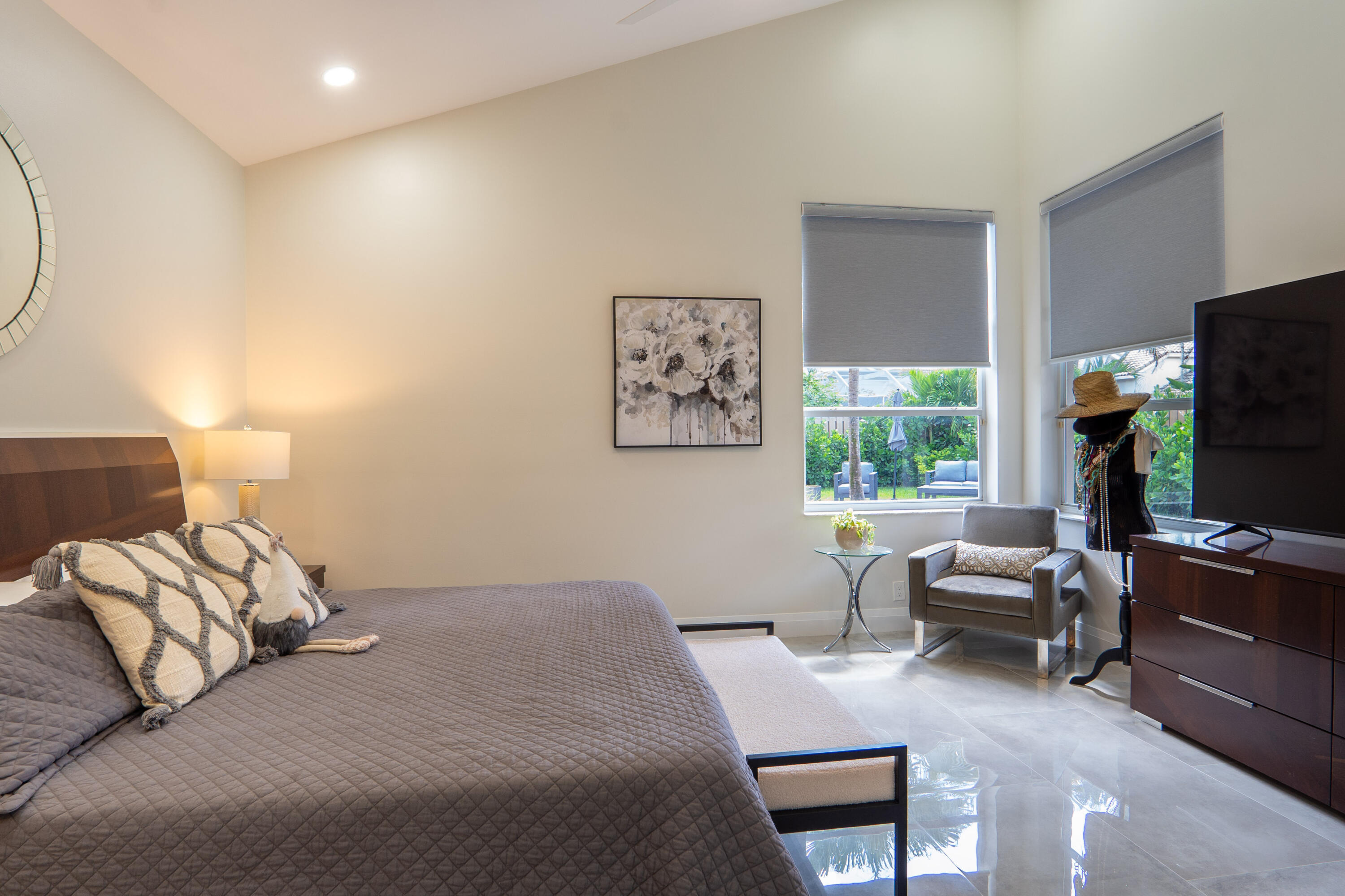 6670 Northwest 27th Avenue Boca Raton, FL 33496 - Photo 17 of 43 a bedroom with a bed and a flat screen tv