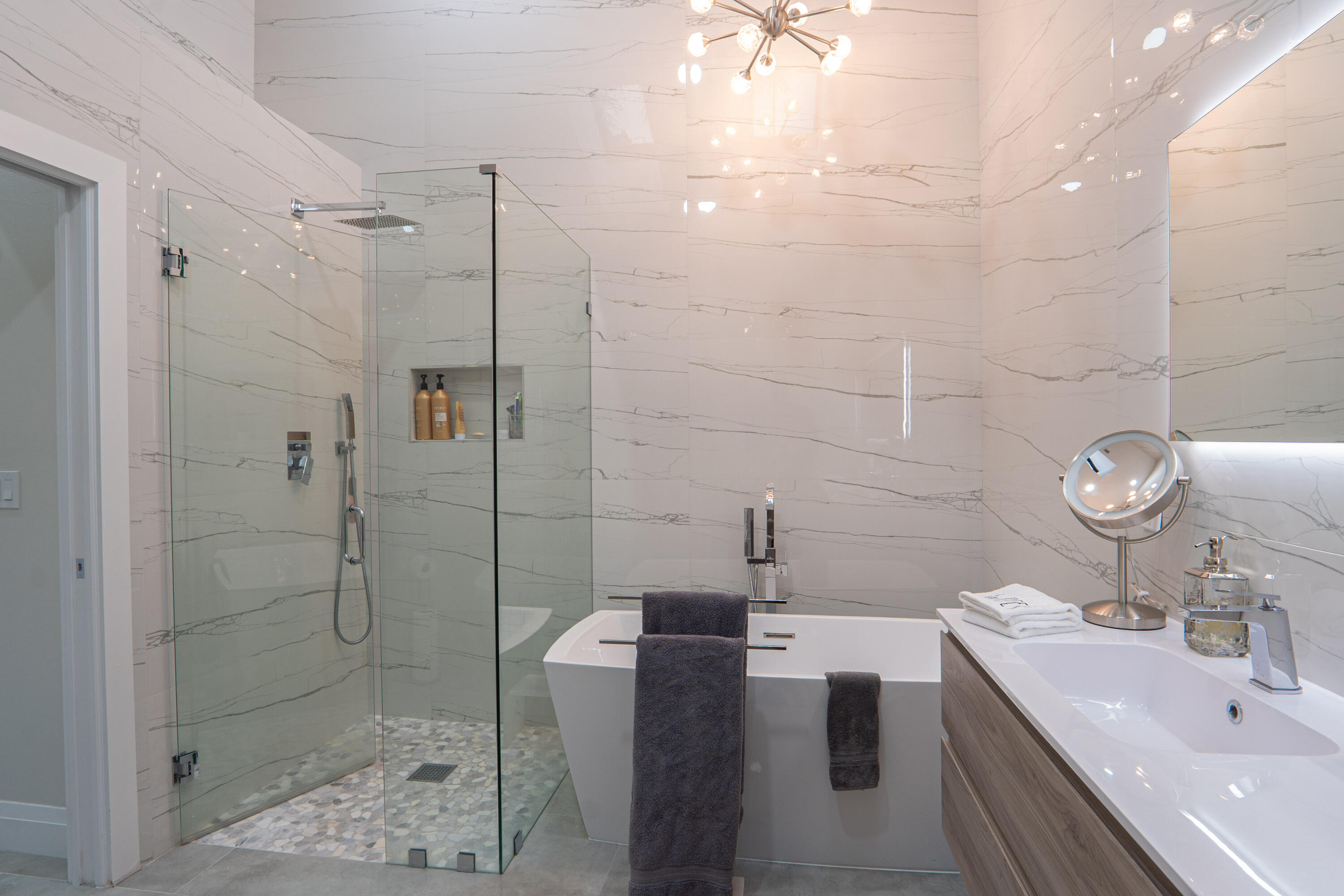 6670 Northwest 27th Avenue Boca Raton, FL 33496 - Photo 18 of 43 a bathroom with a double vanity sink toilet and shower