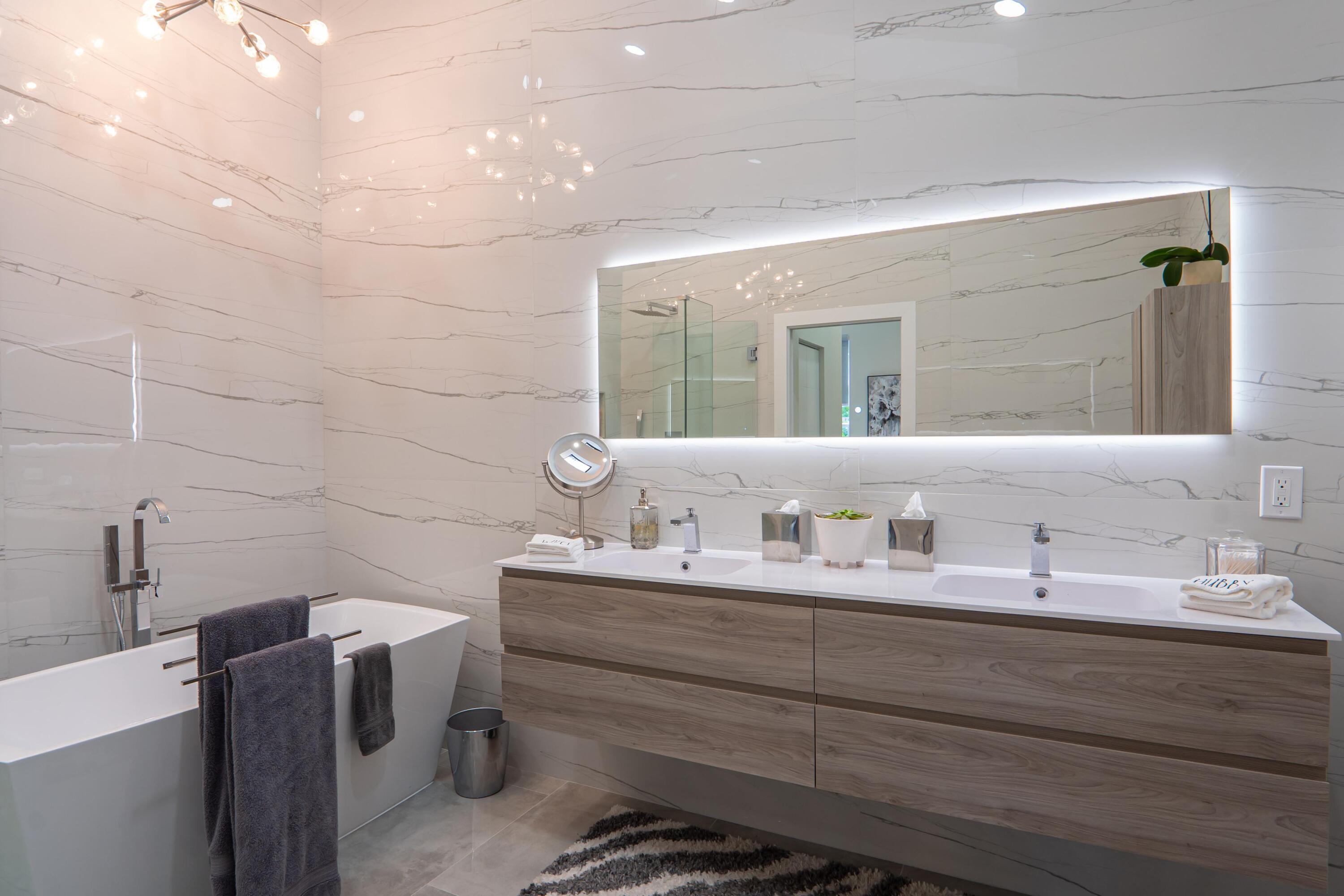 6670 Northwest 27th Avenue Boca Raton, FL 33496 - Photo 19 of 43 a bathroom with a double vanity sink a toilet and a mirror