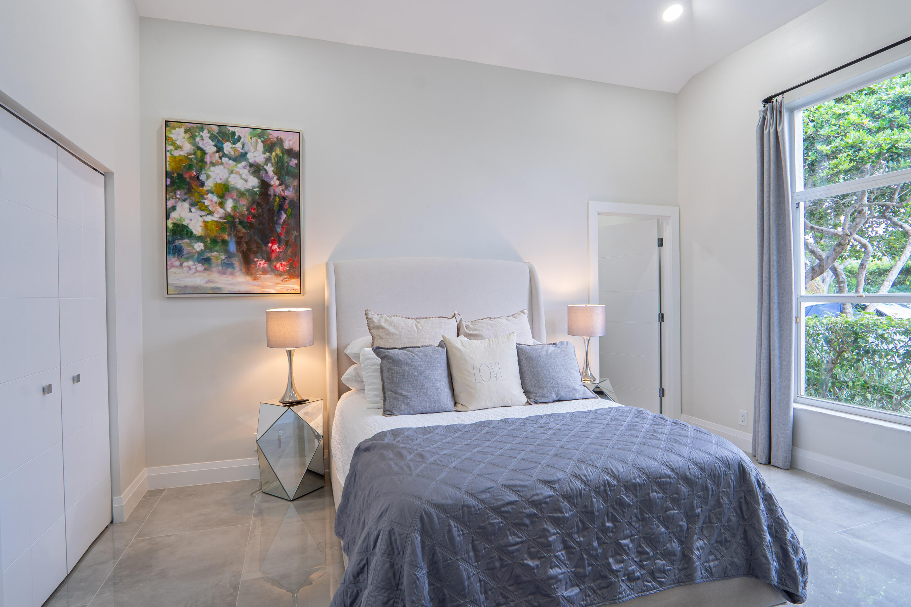 6670 Northwest 27th Avenue Boca Raton, FL 33496 - Photo 22 of 43 a bedroom with a bed and a painting on the wall