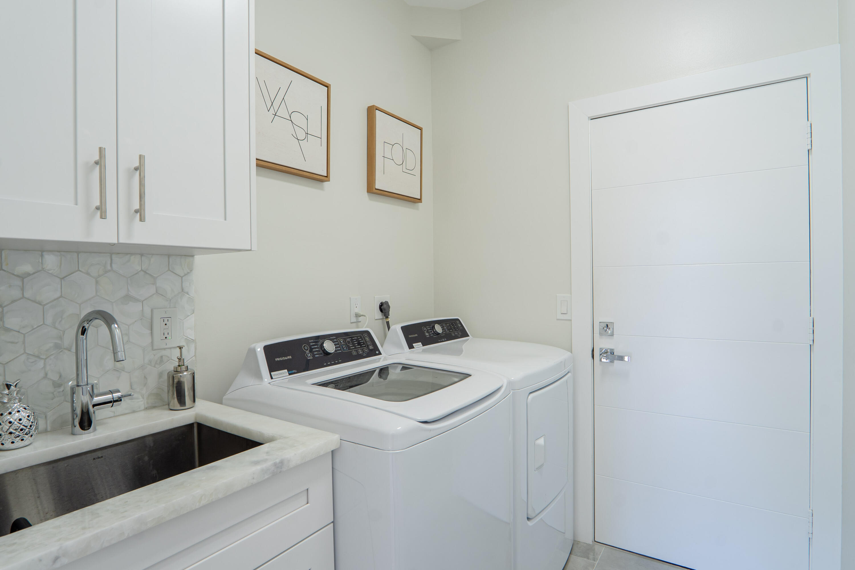 6670 Northwest 27th Avenue Boca Raton, FL 33496 - Photo 26 of 43 a view of storage and utility room with washer and dryer
