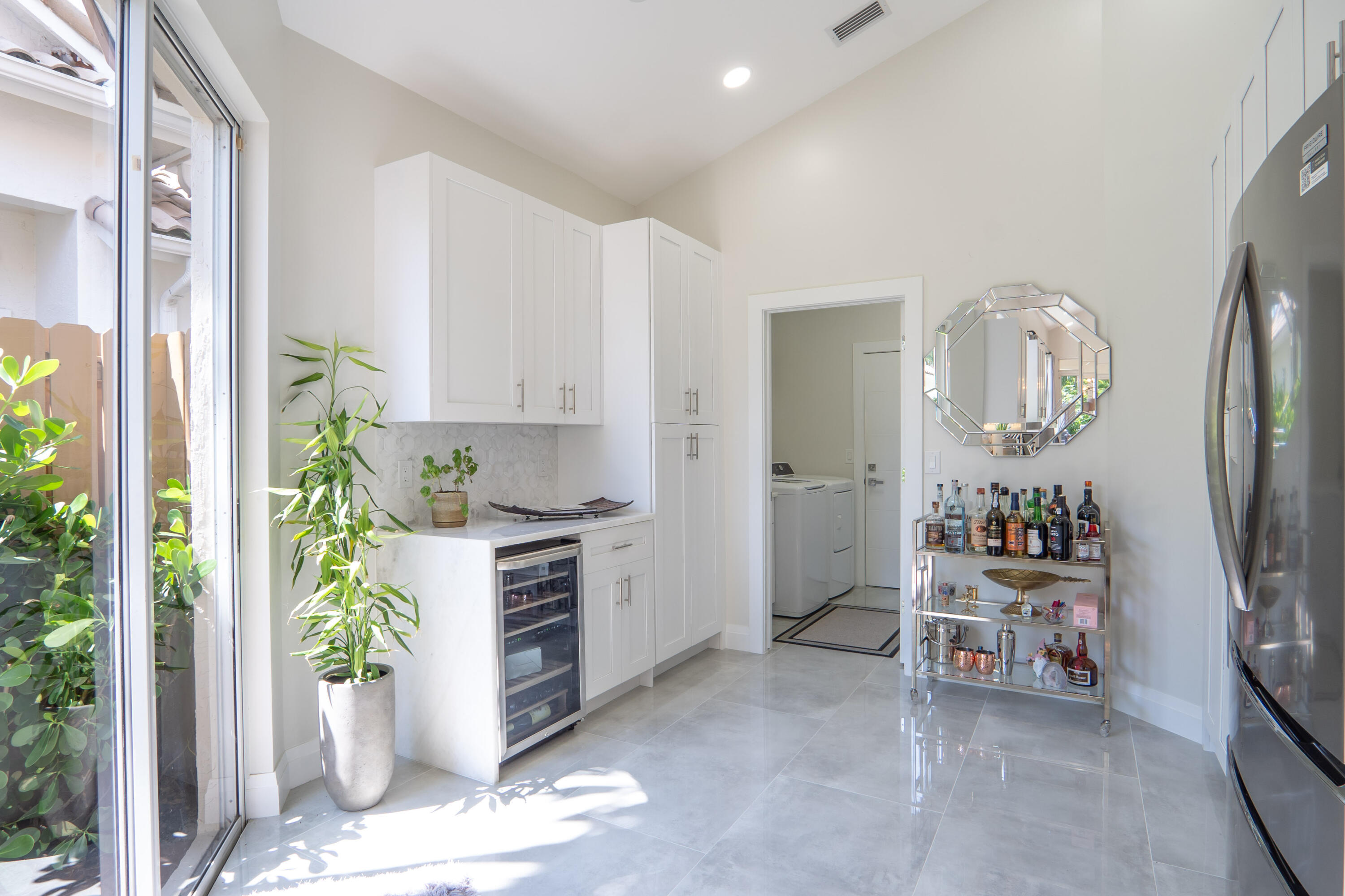 6670 Northwest 27th Avenue Boca Raton, FL 33496 - Photo 29 of 43 a dining room with furniture and a chandelier
