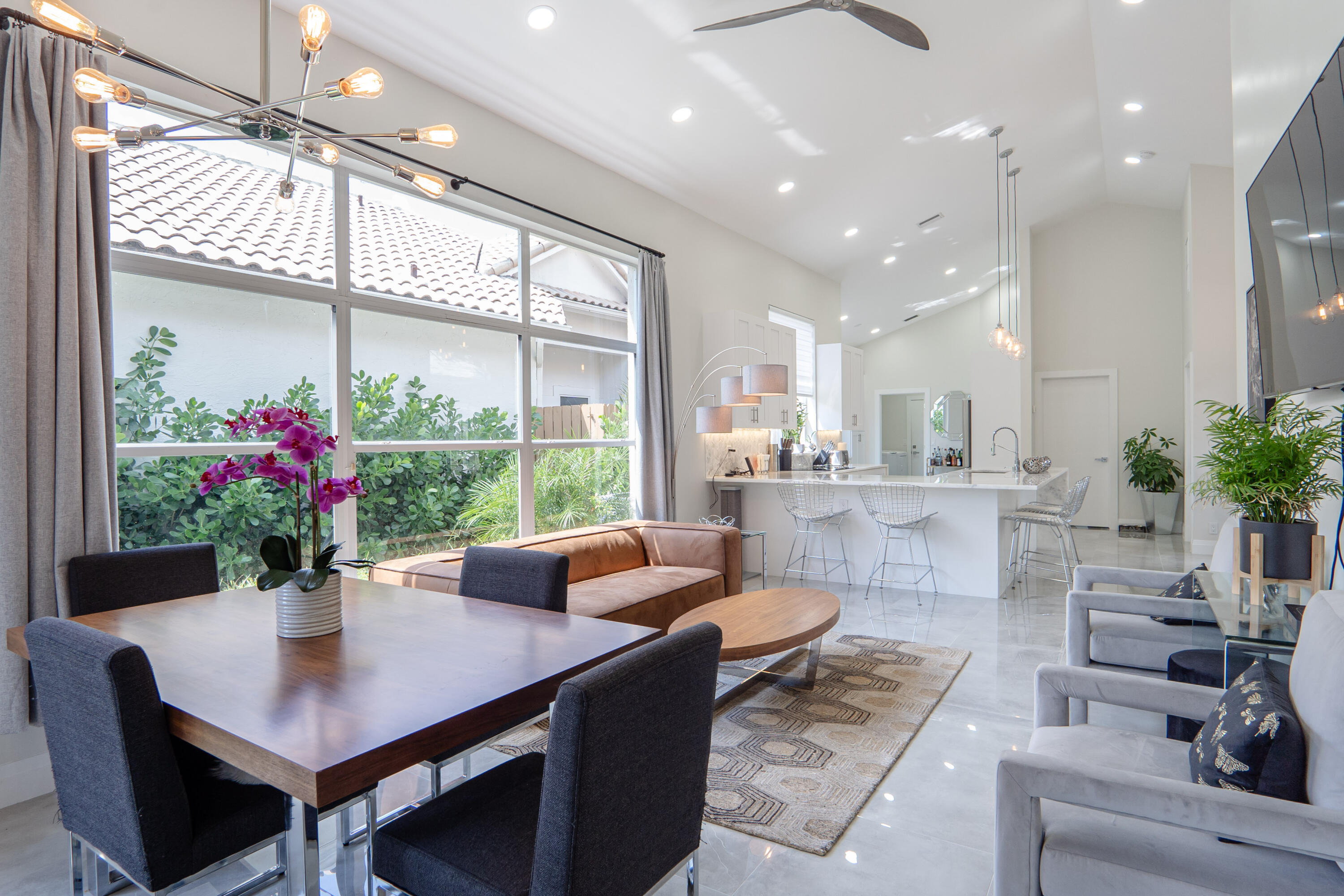 6670 Northwest 27th Avenue Boca Raton, FL 33496 - Photo 40 of 43 a view of a dining room with furniture window and wooden floor