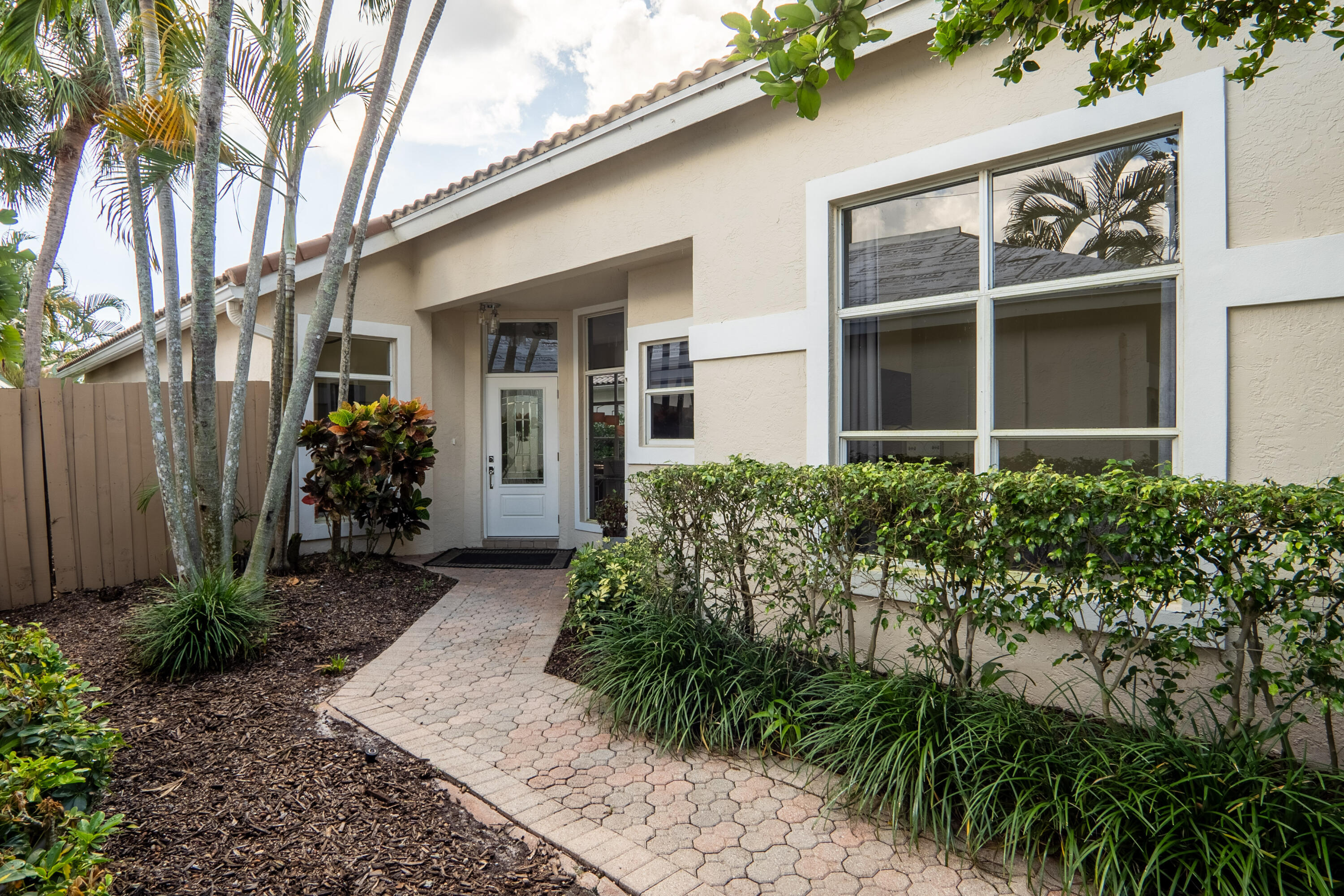 6670 Northwest 27th Avenue Boca Raton, FL 33496 - Photo 5 of 43 a front view of a house with garden