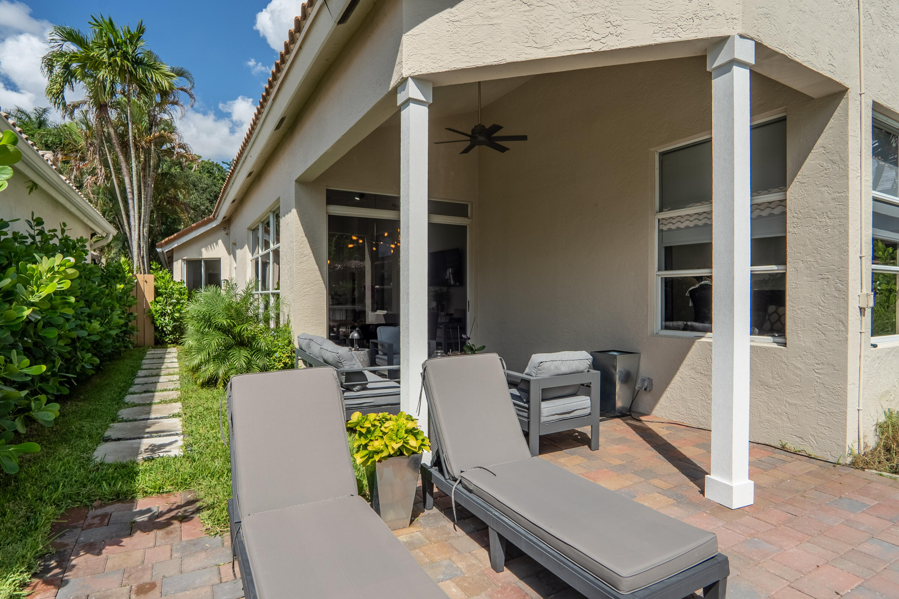 6670 Northwest 27th Avenue Boca Raton, FL 33496 - Photo 8 of 43 a view of a patio with table and chairs and potted plants