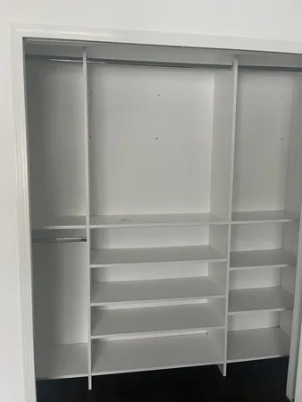 a view of walk in closet with empty racks