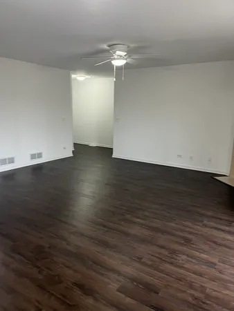 a view of a room with wooden floor