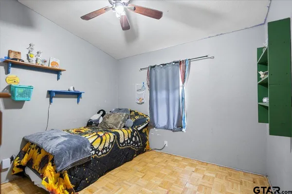 a bedroom with a bed and a flat tv screen