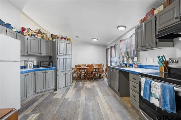 a kitchen with stainless steel appliances granite countertop a refrigerator and a cabinets