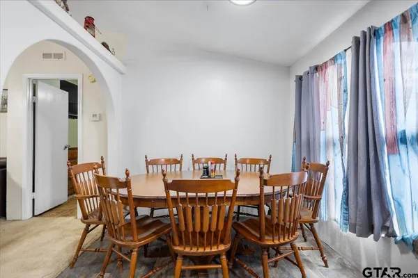 a kitchen with stainless steel appliances a sink cabinets and wooden floor