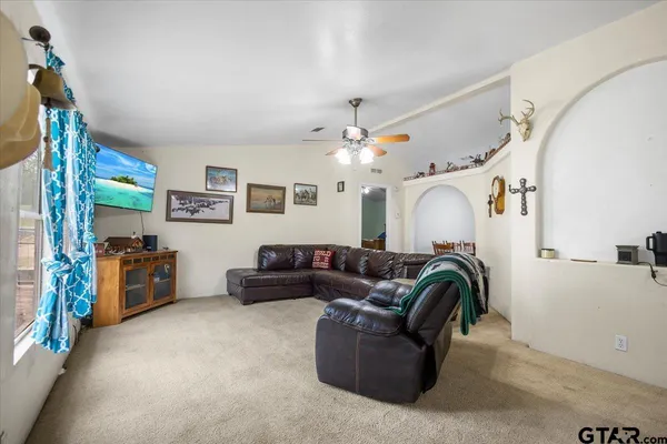 a front view of a house with a yard and lake view