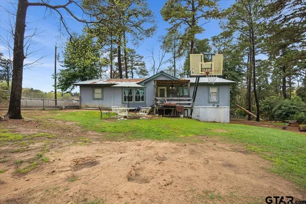 a view of a house with a yard porch and sitting area