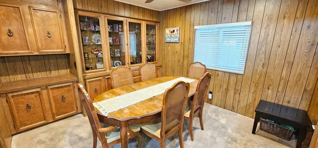 a view of a dining room with furniture and window