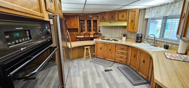 a kitchen with a sink stove and cabinets