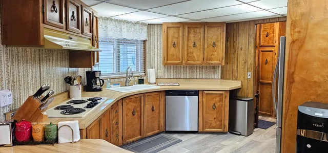 a kitchen with a sink a stove and cabinets