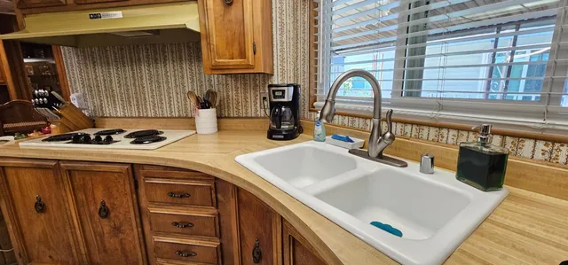 a kitchen with a sink a stove and a window