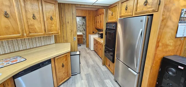 a kitchen with stainless steel appliances a refrigerator and a stove