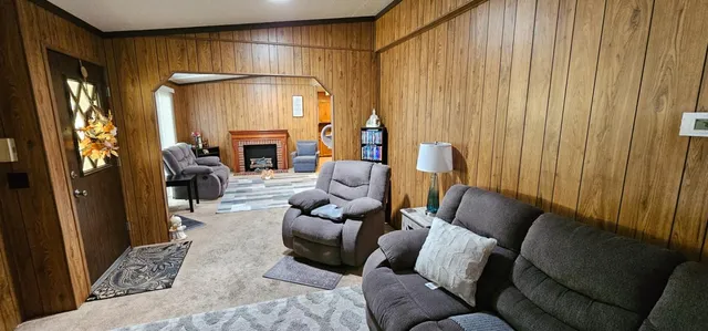 a living room with furniture and a fireplace