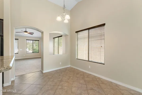 a living room with furniture kitchen view and a flat screen tv