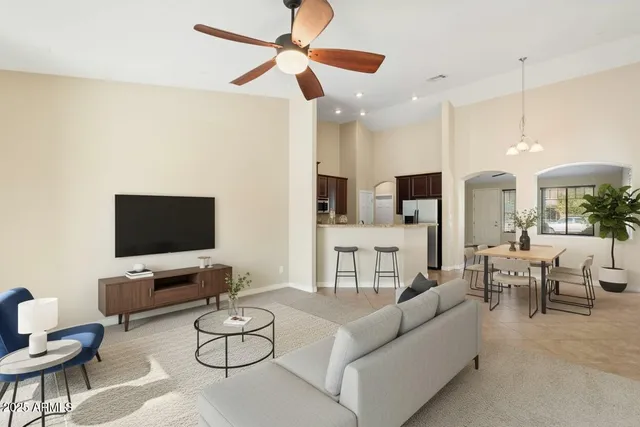 an empty room with fan and windows