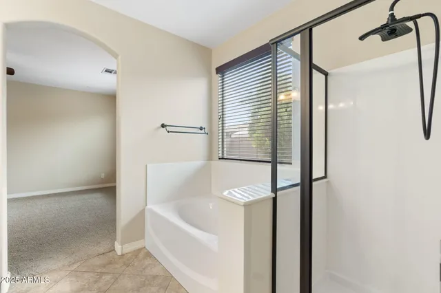 a view of a house with a plants and large tree