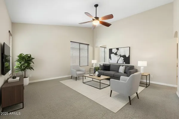 a living room with furniture a ceiling fan and a window