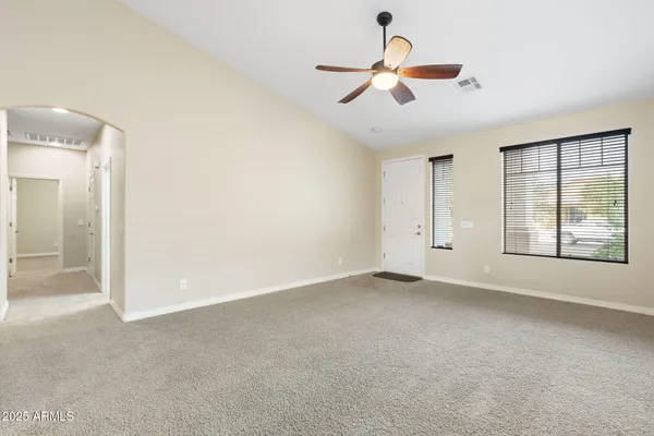 a living room with furniture and a large window with wooden floor