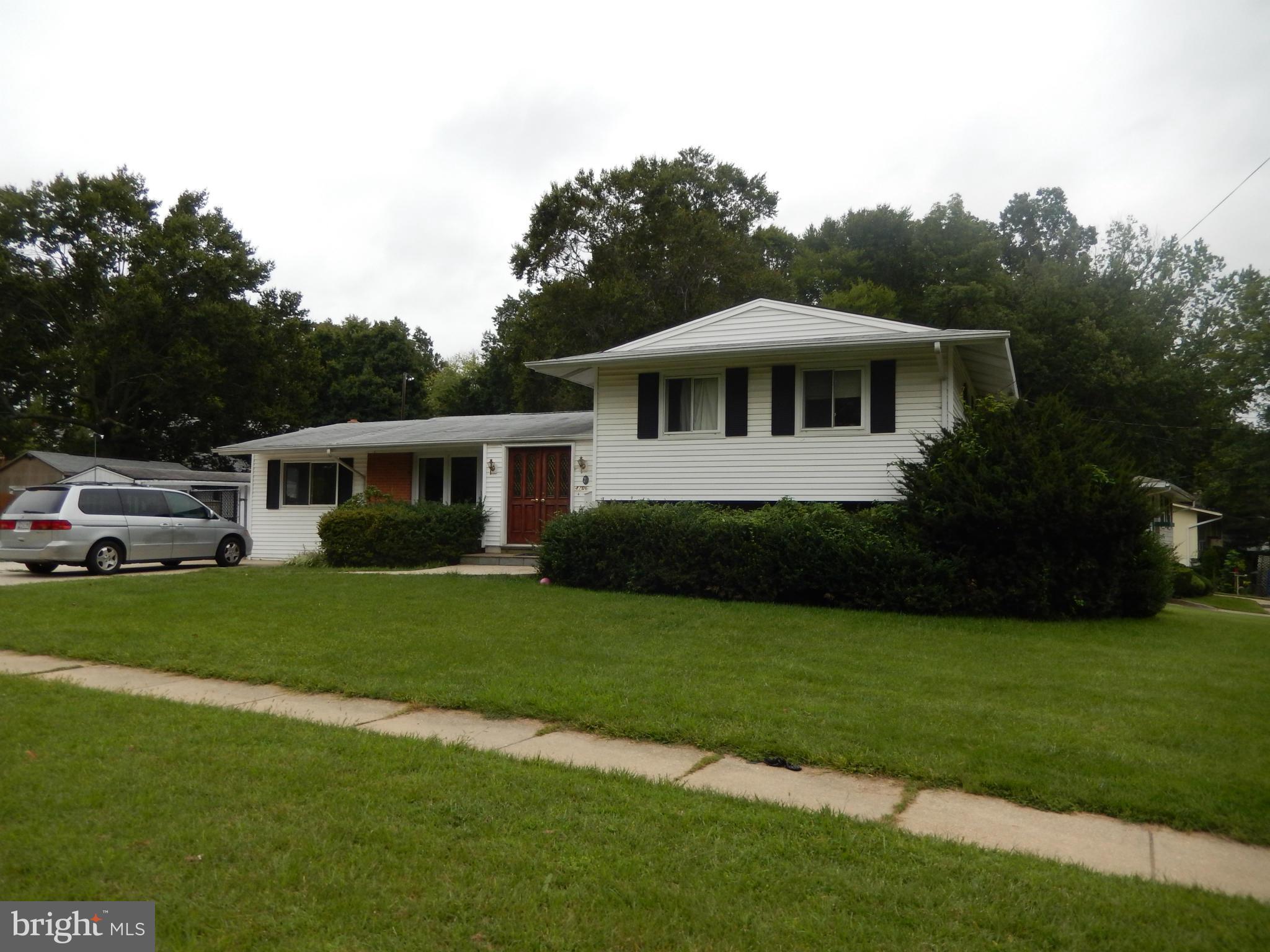 4706 Renn Street Rockville, MD 20853 - Photo 1 of 28 a front view of a house with a garden