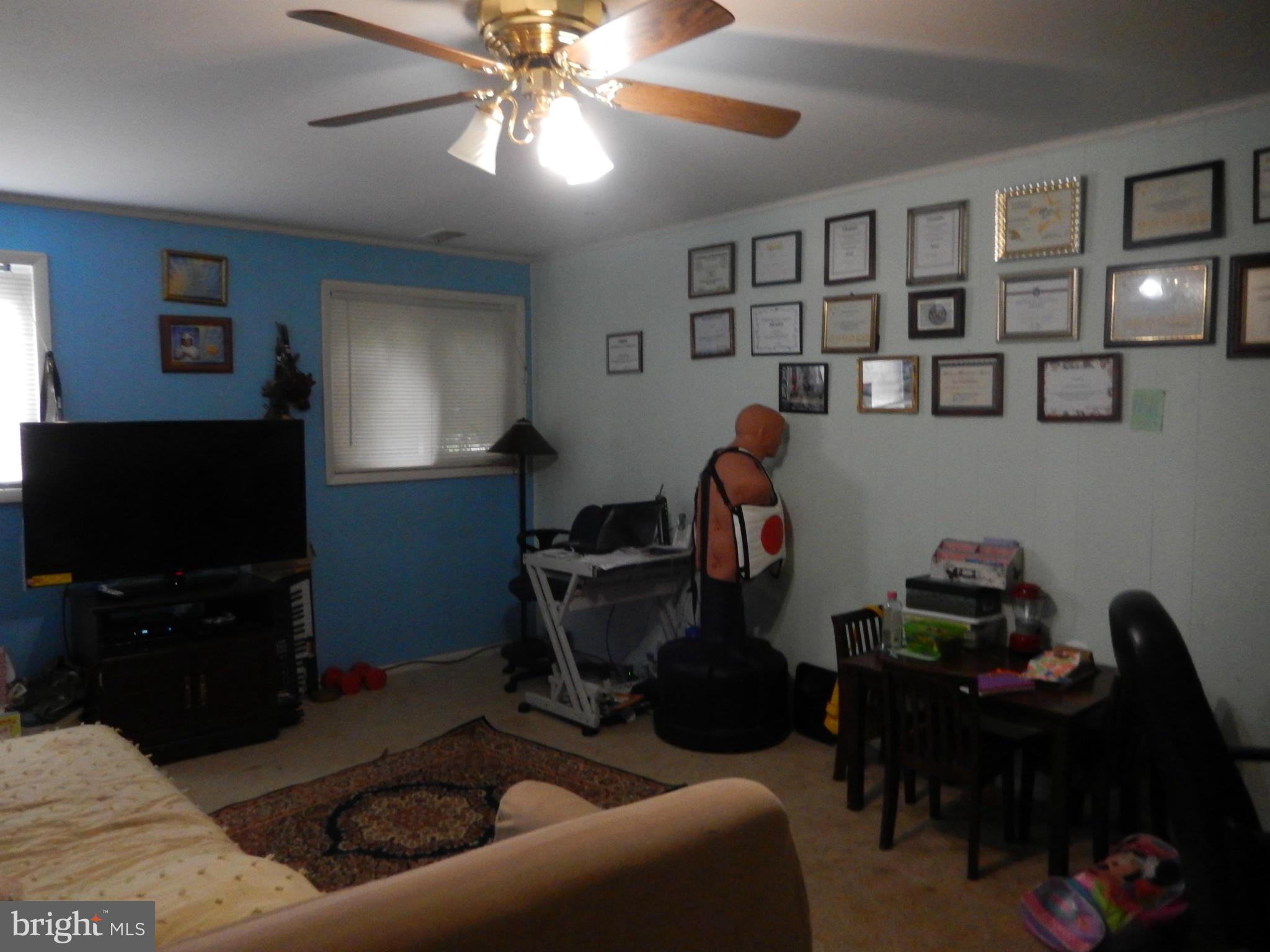 4706 Renn Street Rockville, MD 20853 - Photo 14 of 28 a living room with furniture and a flat screen tv