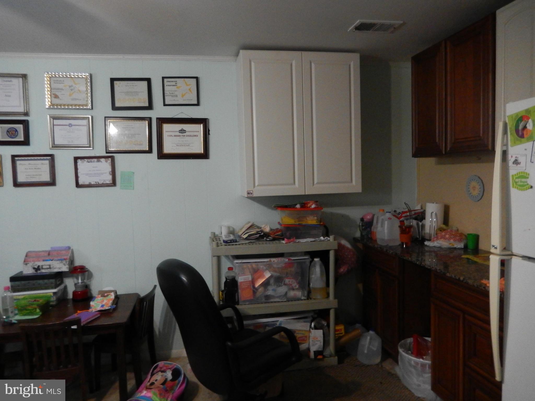 4706 Renn Street Rockville, MD 20853 - Photo 15 of 28 a room with furniture and wooden floor