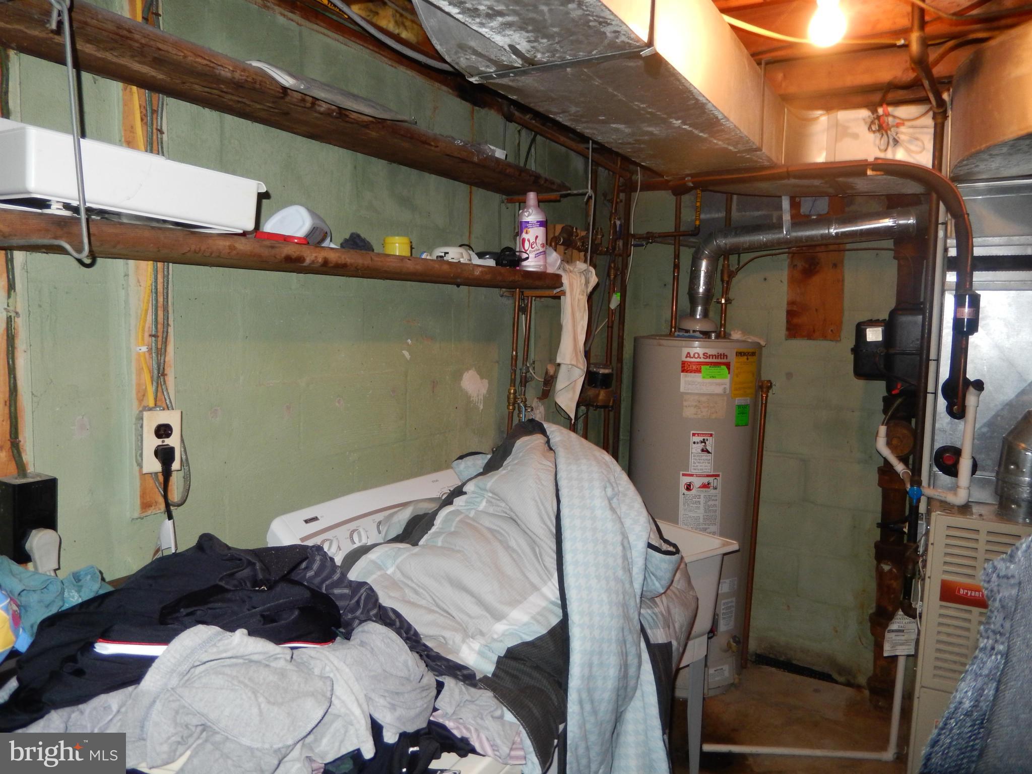 4706 Renn Street Rockville, MD 20853 - Photo 18 of 28 a bedroom with a bed and a walk in closet