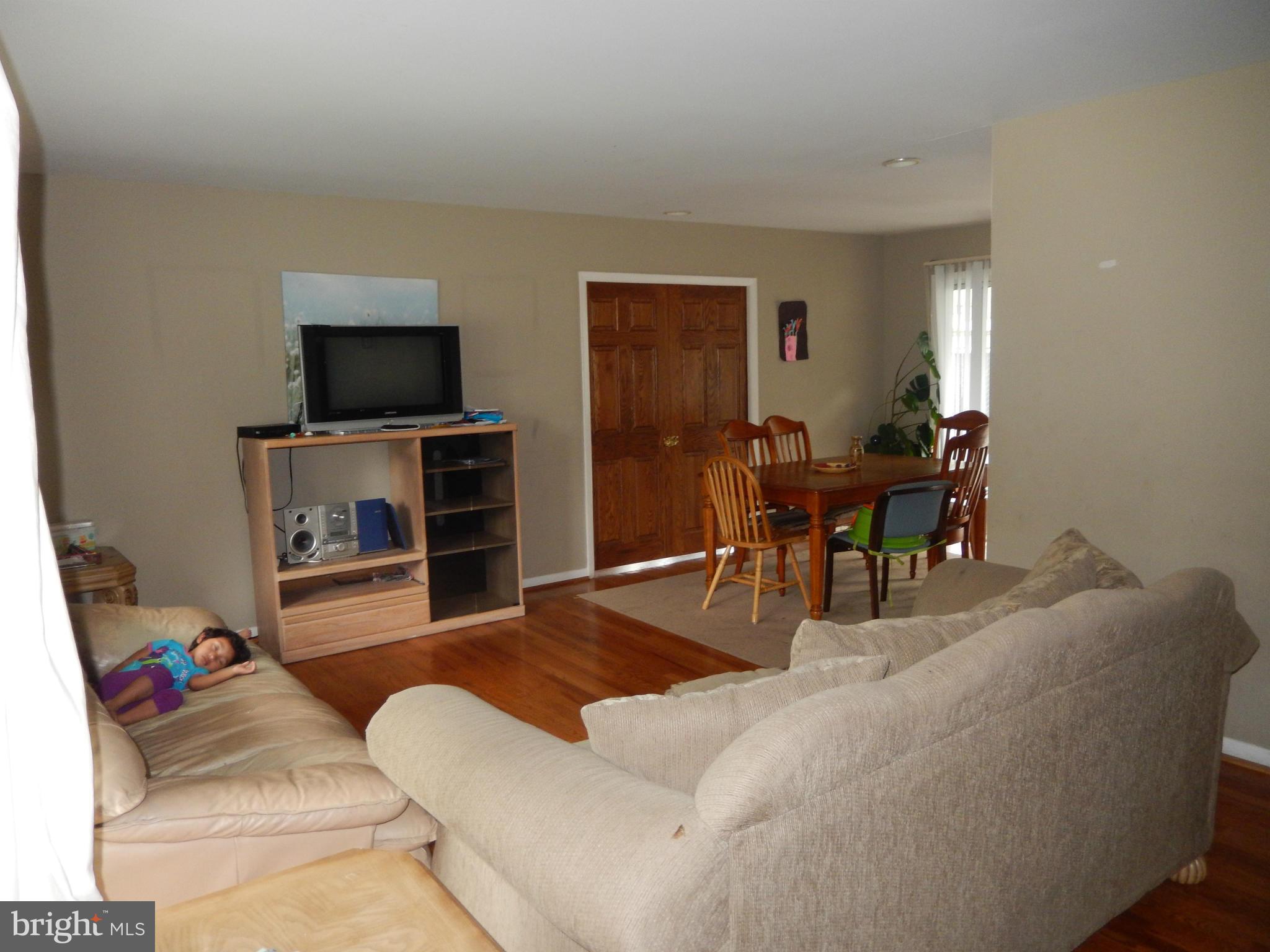 4706 Renn Street Rockville, MD 20853 - Photo 3 of 28 a living room with furniture and a flat screen tv