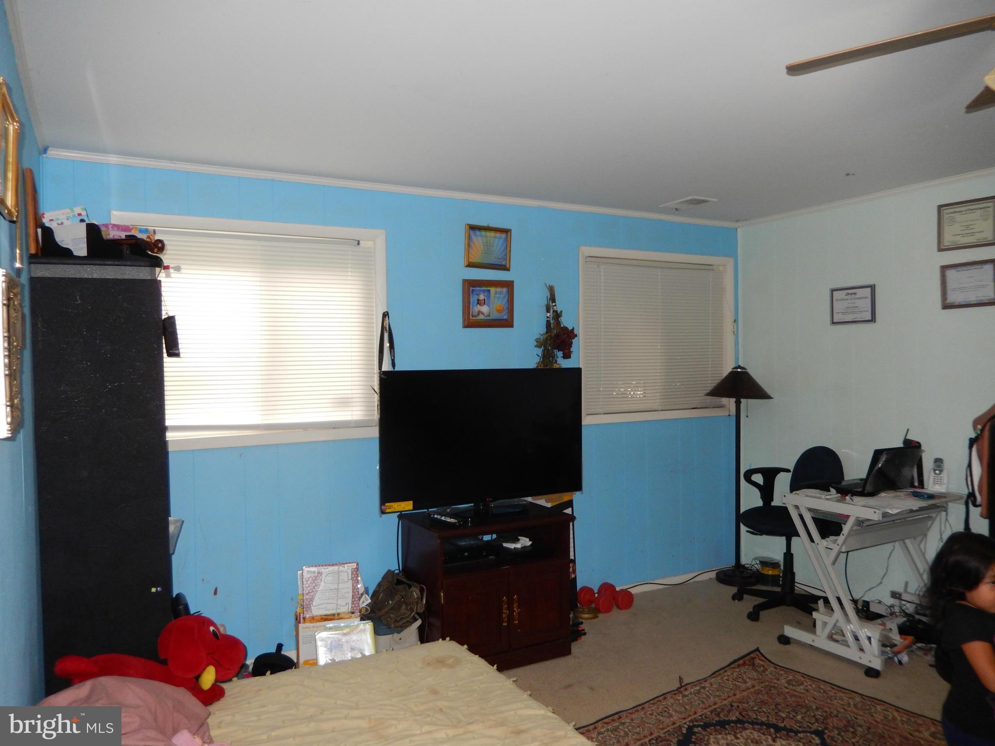4706 Renn Street Rockville, MD 20853 - Photo 22 of 28 a living room with furniture and a flat screen tv