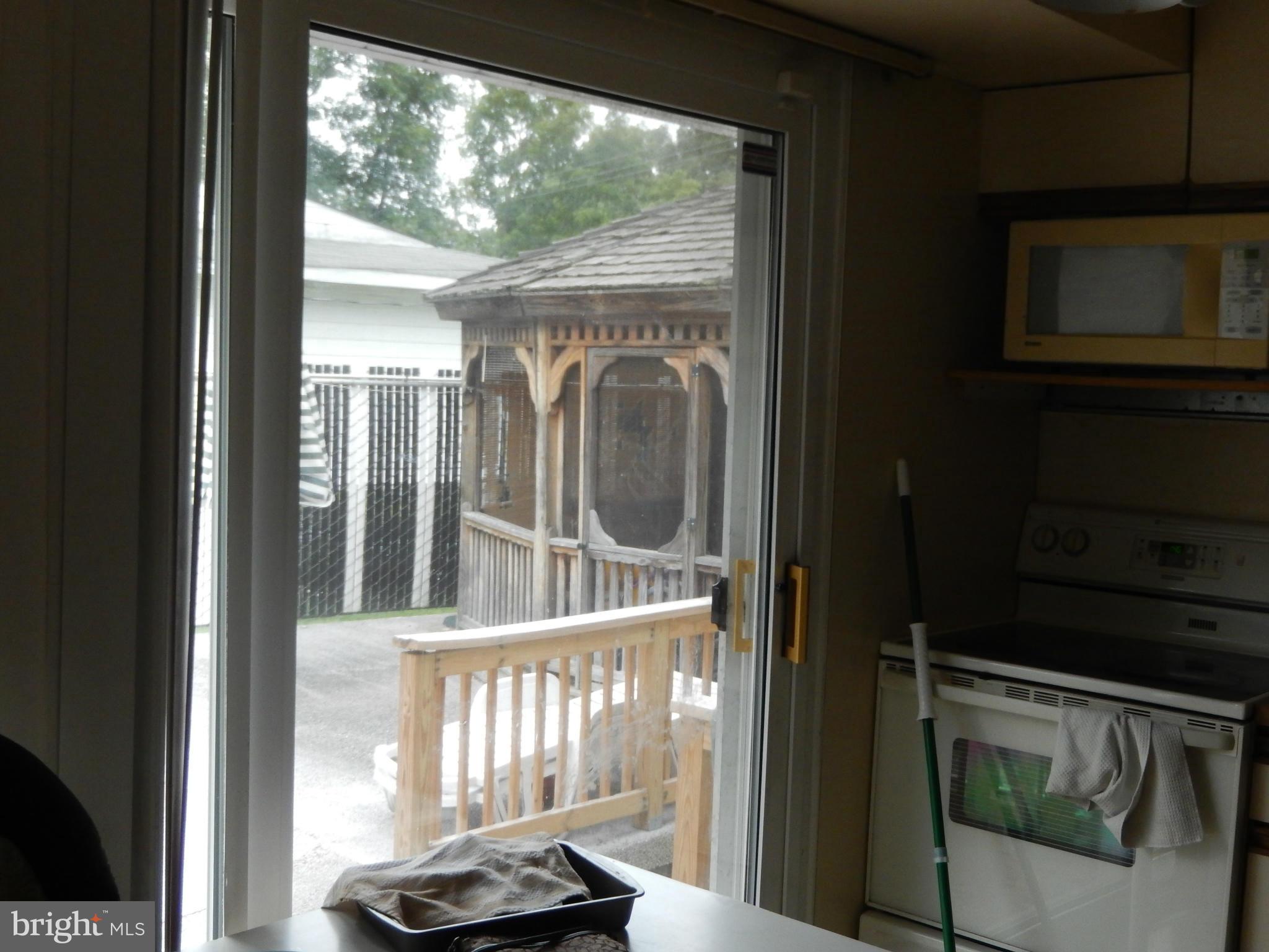 4706 Renn Street Rockville, MD 20853 - Photo 27 of 28 a view of a porch with a floor to ceiling window and an entryway