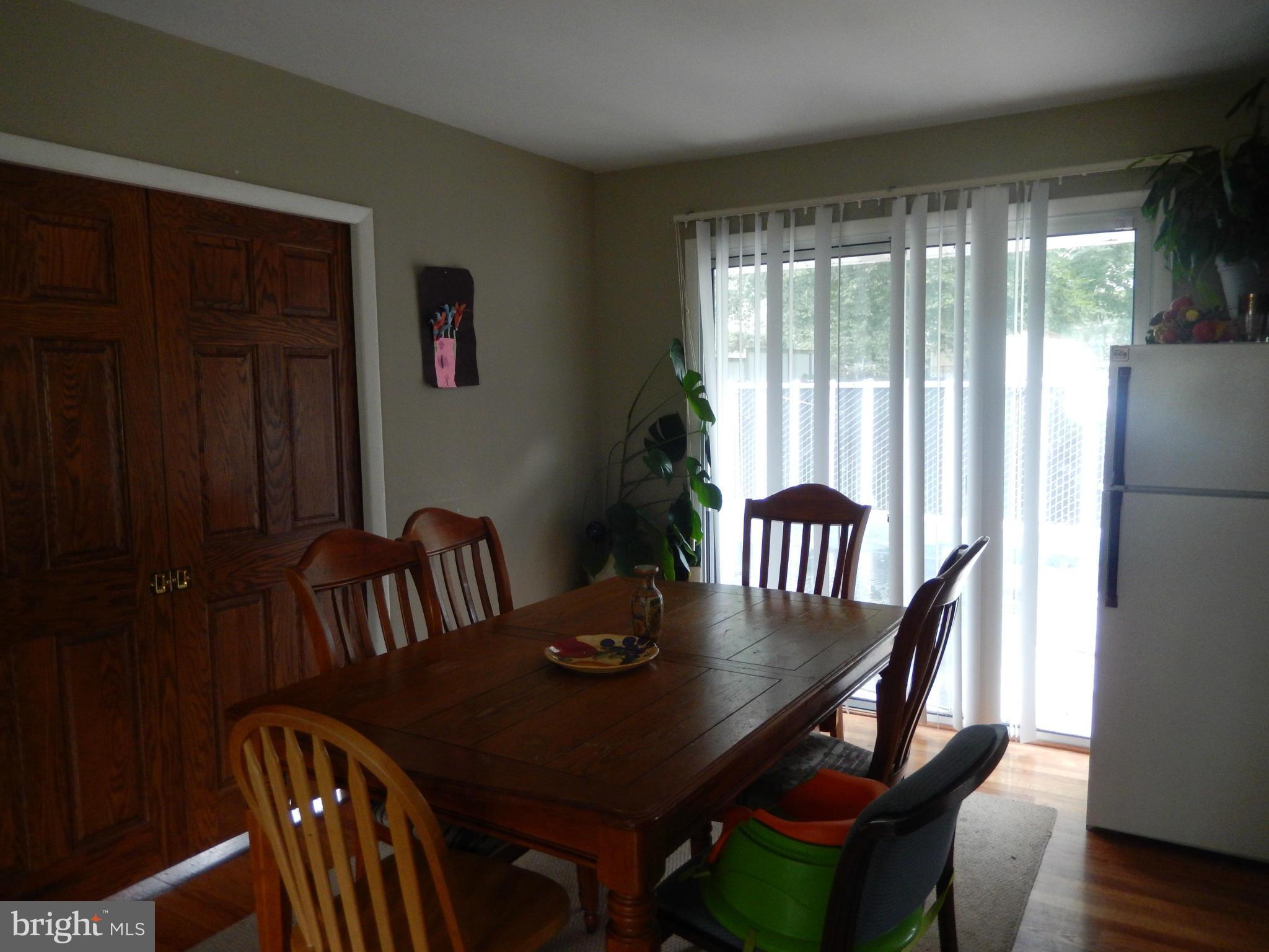 4706 Renn Street Rockville, MD 20853 - Photo 4 of 28 a view of a dining room with furniture window and wooden floor