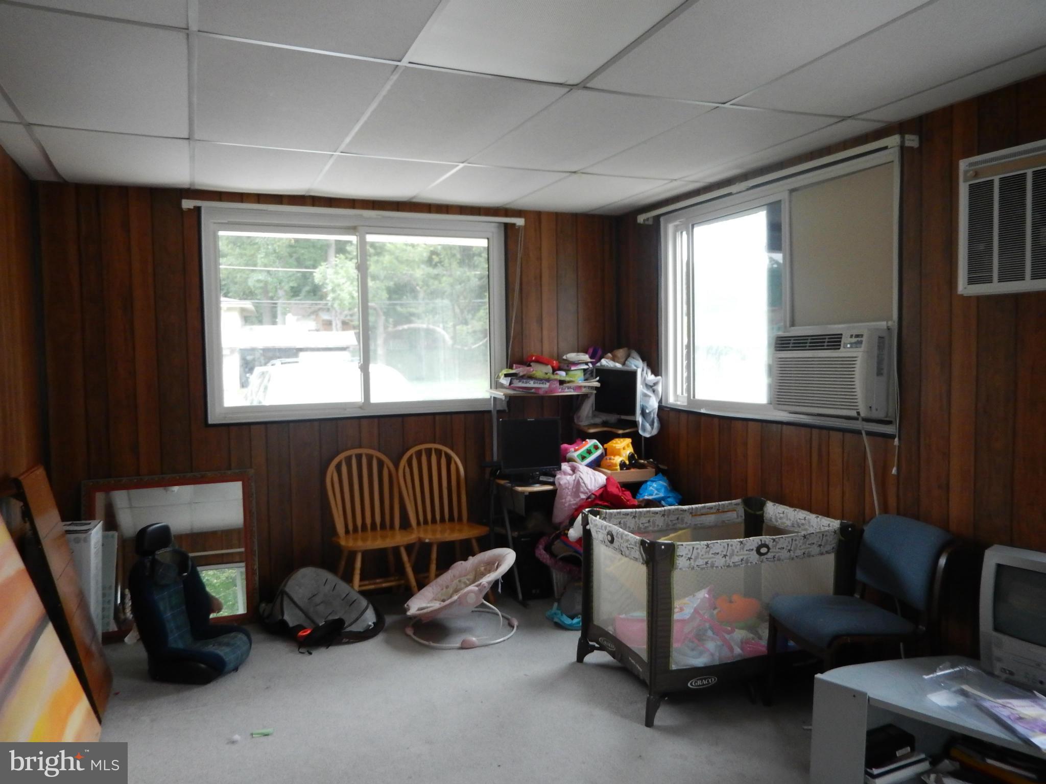 4706 Renn Street Rockville, MD 20853 - Photo 6 of 28 a living room with furniture and a window