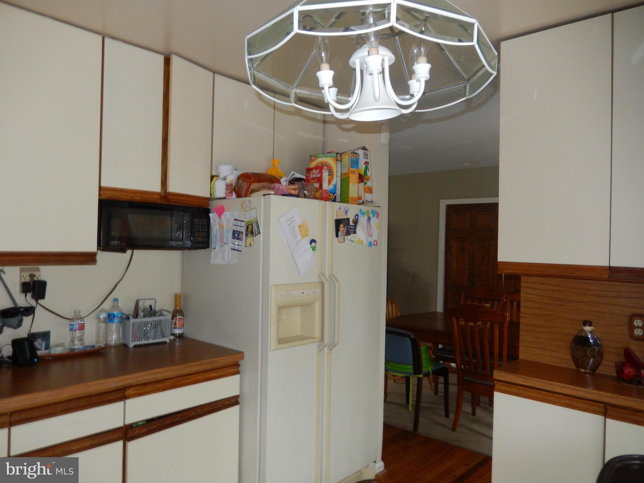 4706 Renn Street Rockville, MD 20853 - Photo 8 of 28 a kitchen with a refrigerator and a sink